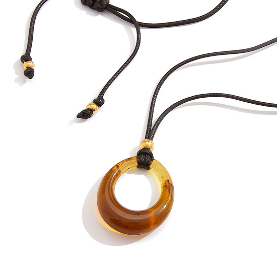 Black Cord Necklace with a brown amber pendant on a white background