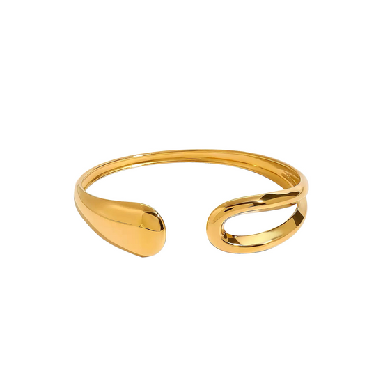 Gold open bangle on a white background