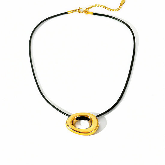 Necklace with gold circular pendants on a black cord against a white background