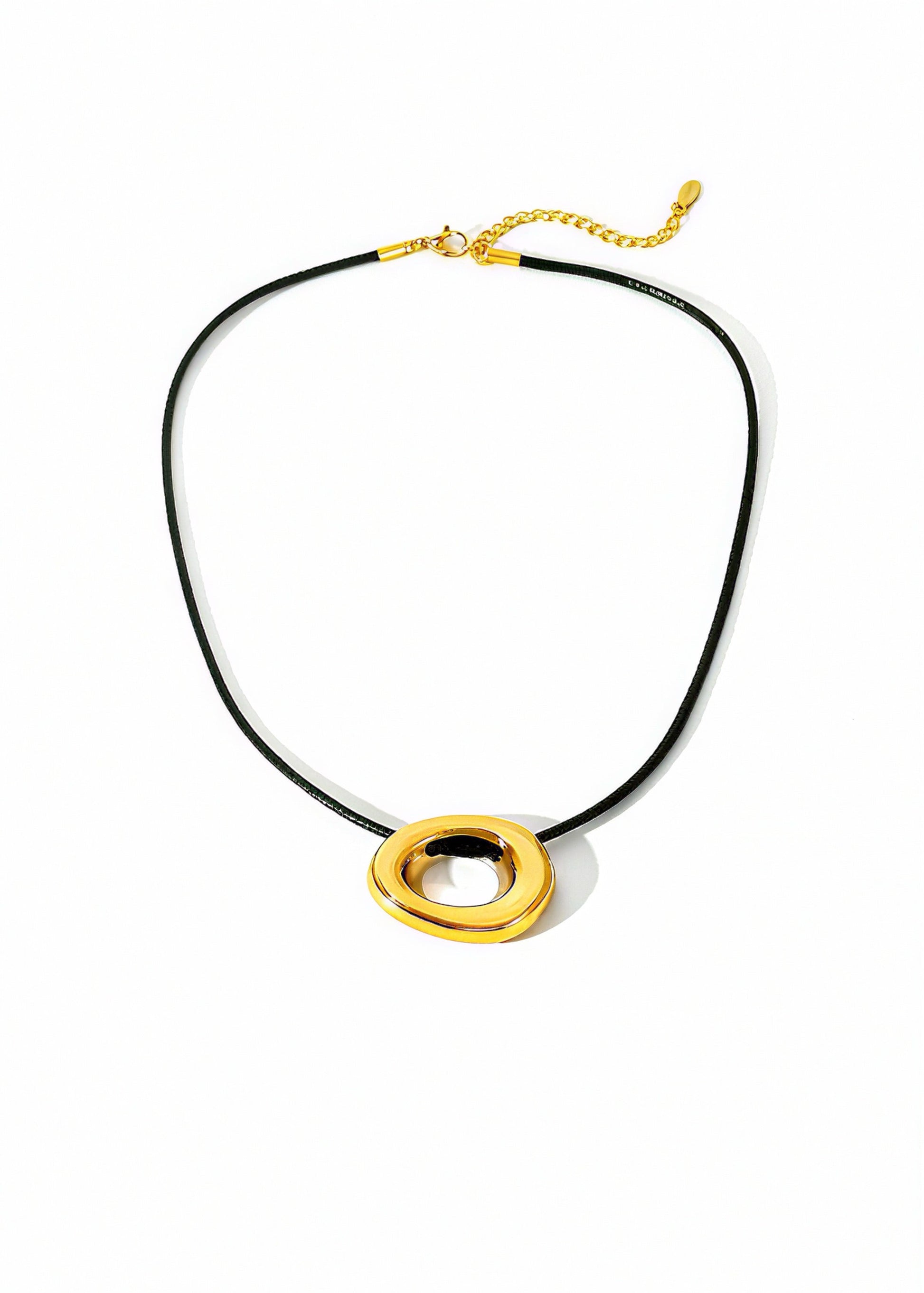Necklace with gold circular pendants on a black cord against a white background
