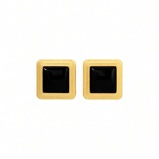 Pair of square-shaped earrings with black centers and gold borders on a white background