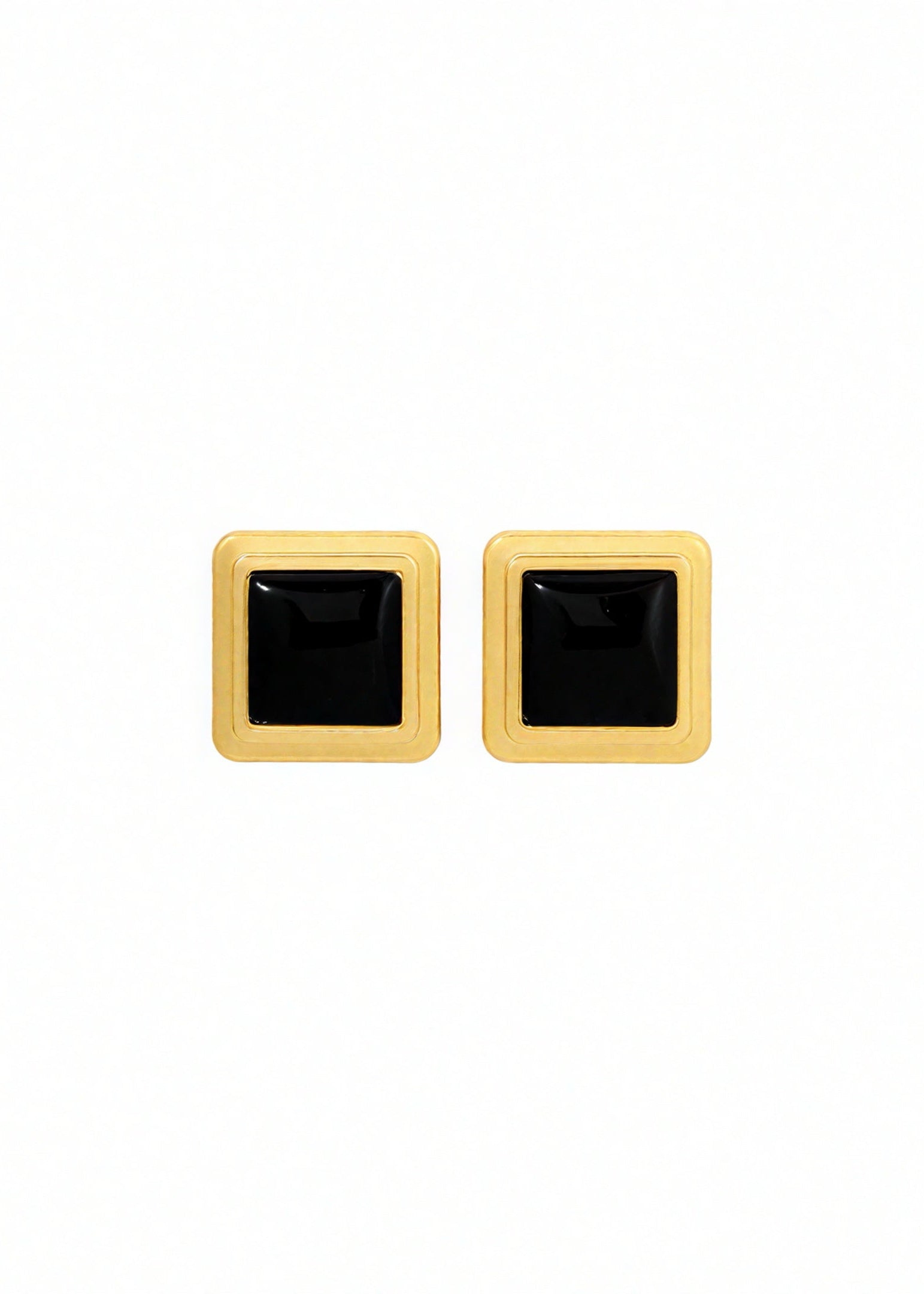 Pair of square-shaped earrings with black centers and gold borders on a white background