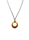 Amber circular pendant on a black cord against a white background