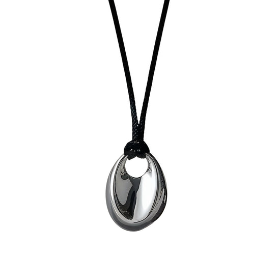 Black necklace with a silver pendant on a white background