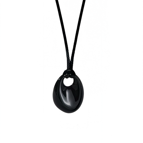 Black oval pendant necklace on a white background