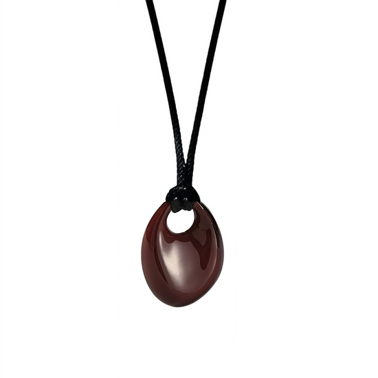 Brown red pendant on a black cord against a white background