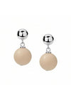 Pair of earrings with beige spherical beads and silver tops on a white background