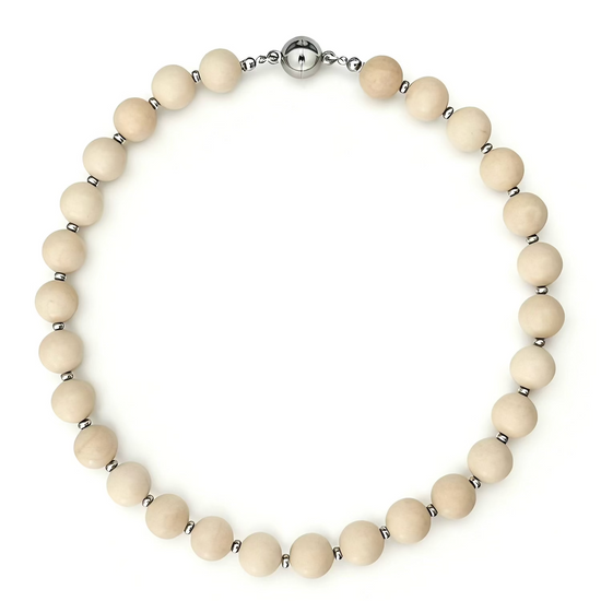 Necklace with cream-colored beads and silver clasp on a white background