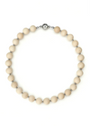 Necklace with cream-colored beads and silver clasp on a white background