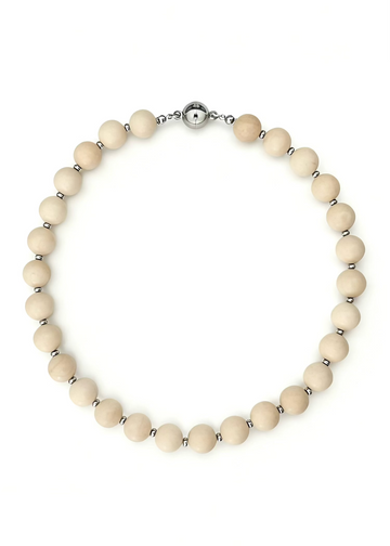 Necklace with cream-colored beads and silver clasp on a white background