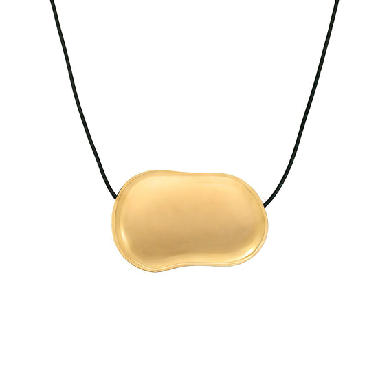 Gold pebble pendant on a black cord against a white background