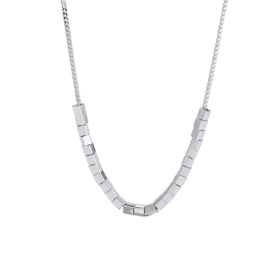Silver necklace with square beads on a white background