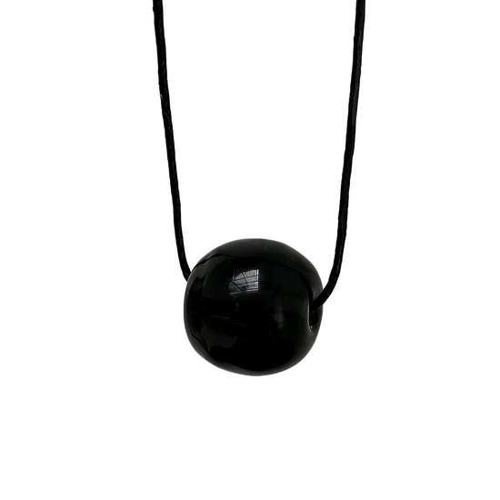 Black necklace with a round pendant on a white background