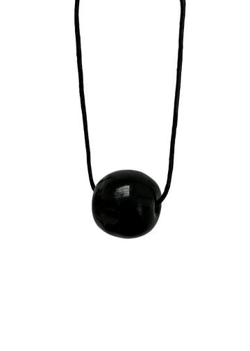 Black necklace with a round pendant on a white background