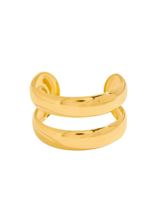 Gold cuff bangle on a white background
