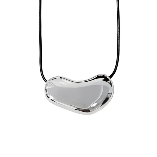 Heart-shaped silver pendant on a black cord against a white background